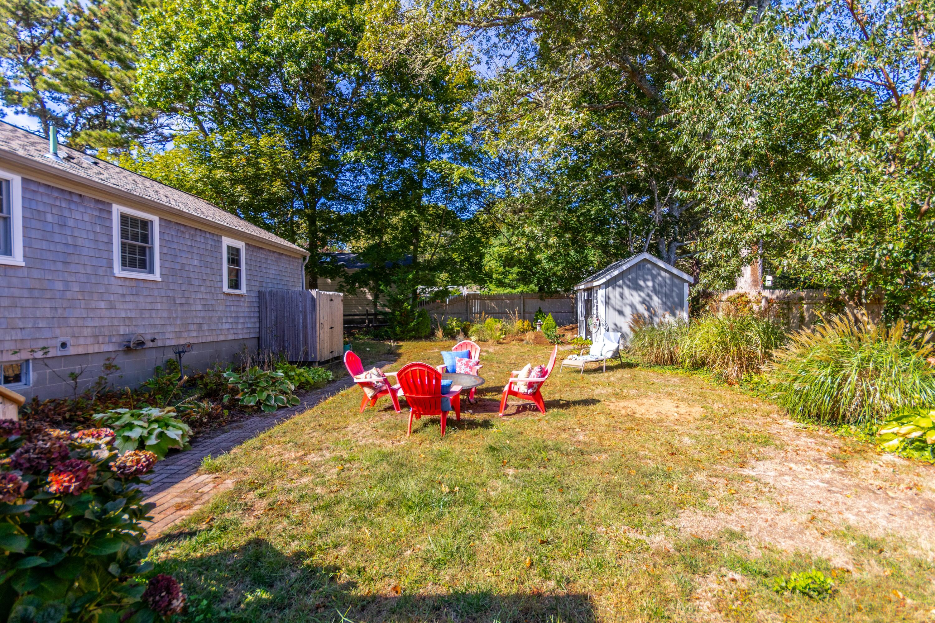 42 Agnes Road South Dennis, MA 02660 - Photo 33 of 36 a view of backyard with potted plants and large tree