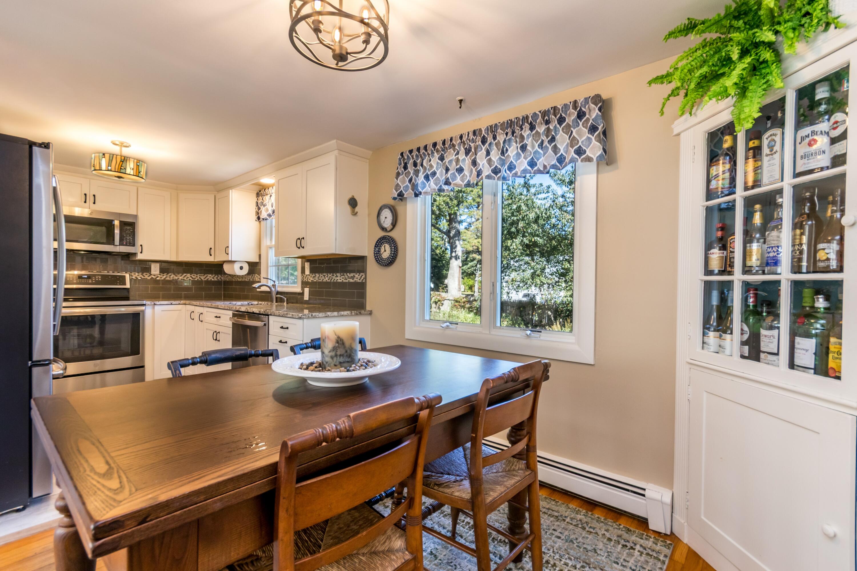 42 Agnes Road South Dennis, MA 02660 - Photo 8 of 36 a kitchen with a table chairs and microwave