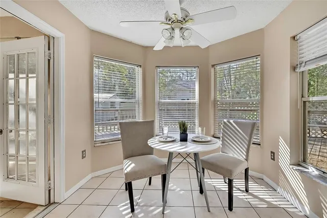 a kitchen with a stove a sink and chairs