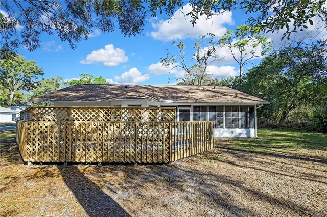 a view of deck with wooden floor and fence and trees
