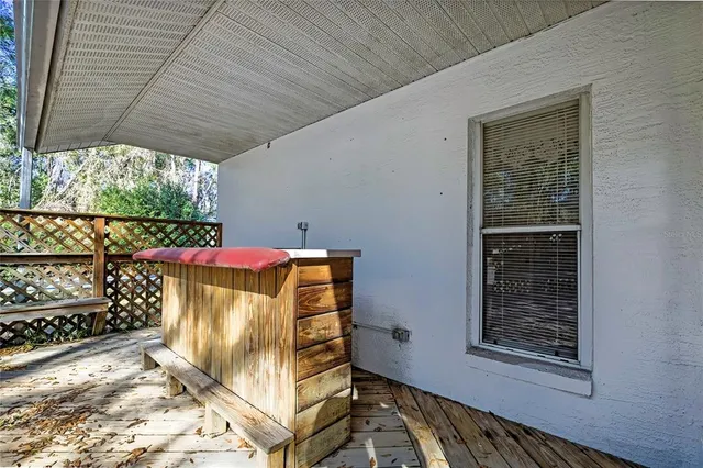 a view of deck with wooden floor and fence and trees