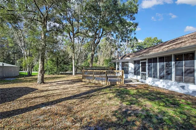 a view of a house with a yard and wooden fence