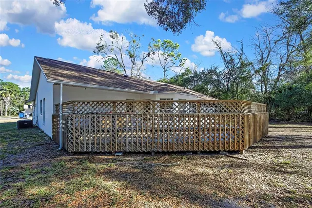 a backyard of a house with table and chairs