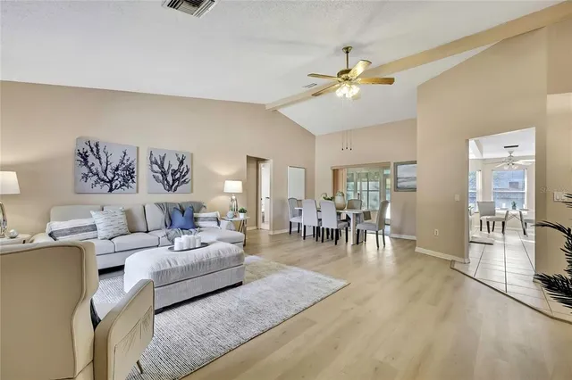 a living room with furniture chandelier and a large window