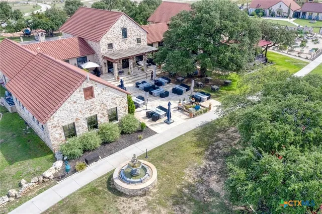 a view of a house with yard and sitting area
