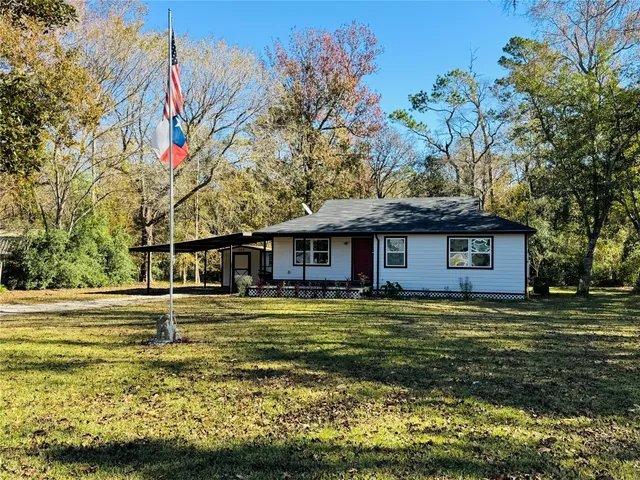 a house that has a large tree in front of it