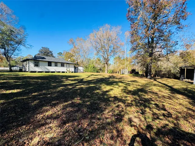 a front view of a house with yard and green space