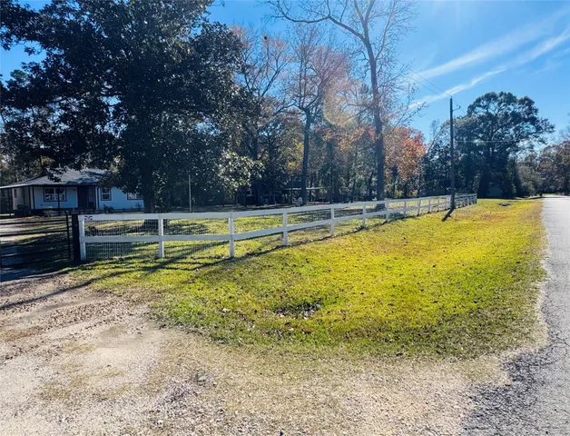 a view of a swimming pool with lawn chairs under an umbrella