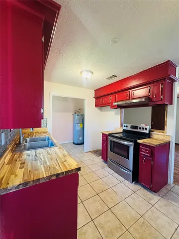 a kitchen with stainless steel appliances granite countertop a stove a sink and dishwasher