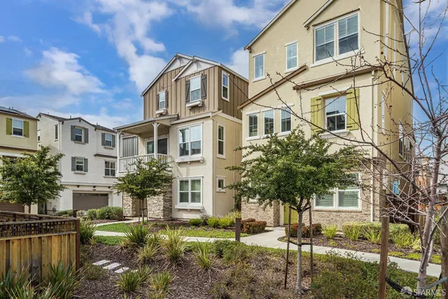 a front view of a residential apartment building with a yard