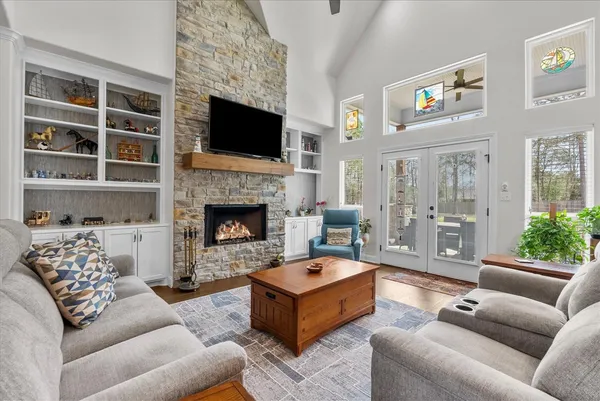 a living room with furniture kitchen view and a table