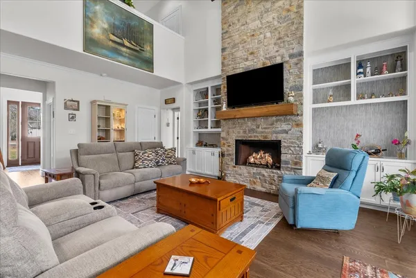 a dining room with furniture a chandelier and wooden floor