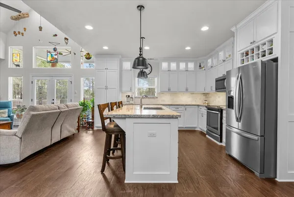 a kitchen with stainless steel appliances granite countertop a stove and a microwave