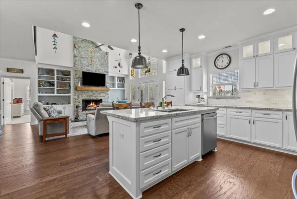 a kitchen with stainless steel appliances white cabinets and a stove