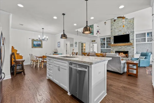 a spacious bedroom with a bed and a chandelier