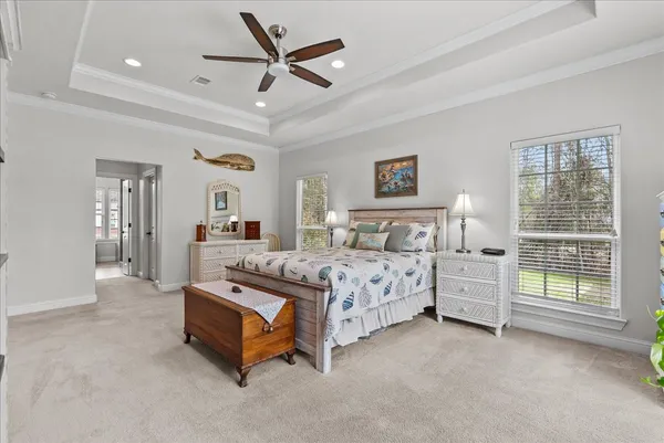 a bedroom with a bed dresser and a window