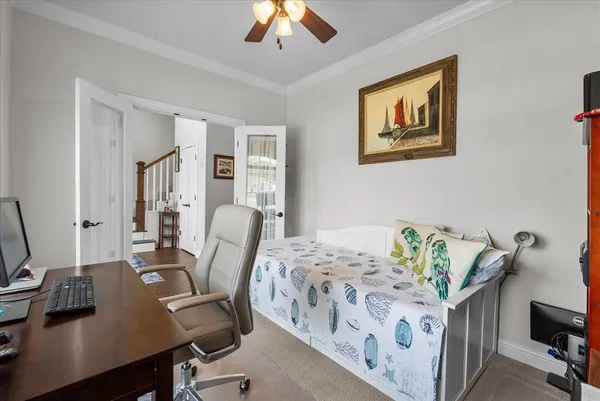 a bedroom with bed and a chandelier