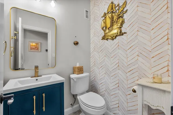 a bathroom with a granite countertop sink a toilet and a bathtub