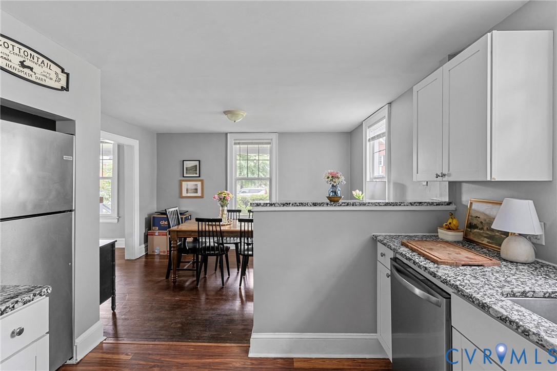 104 West Union Street Sandston, VA 23150 - Photo 15 of 33 a kitchen with stainless steel appliances granite countertop a refrigerator a stove a dining table and chairs