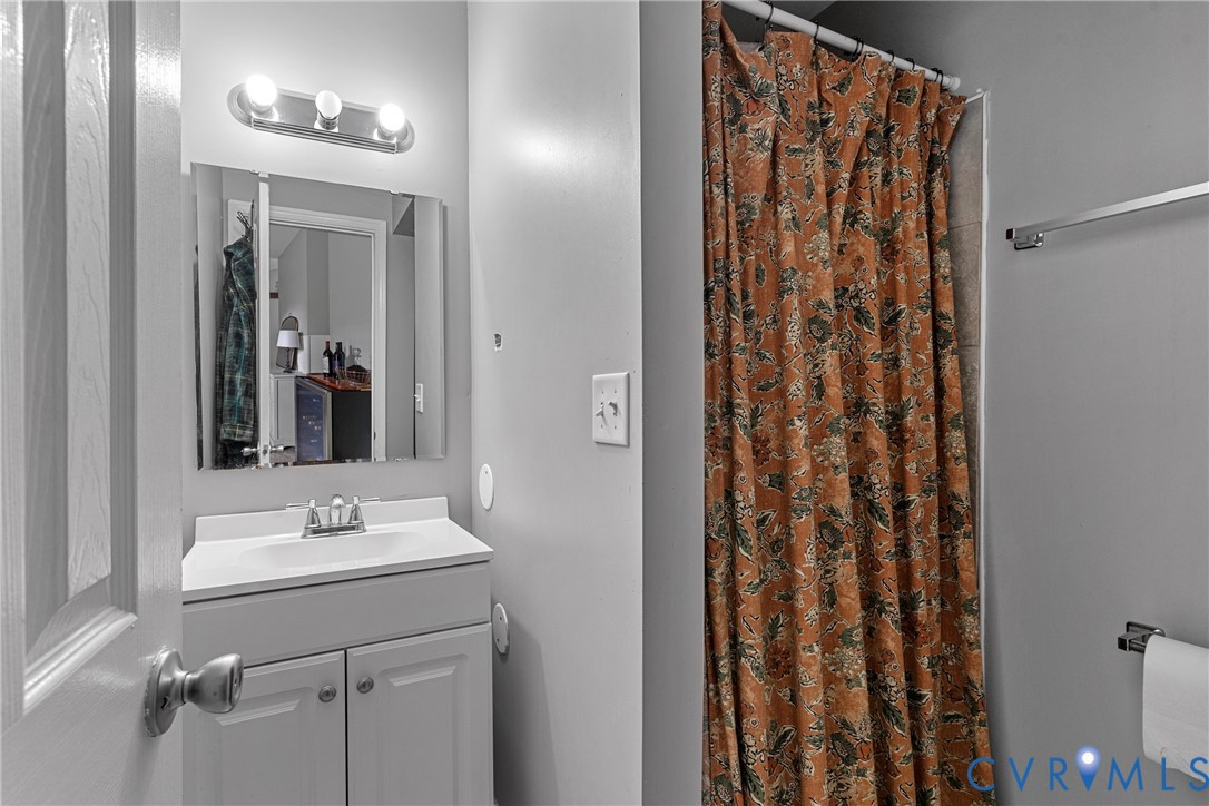 104 West Union Street Sandston, VA 23150 - Photo 19 of 33 a bathroom with a sink a mirror and a shower