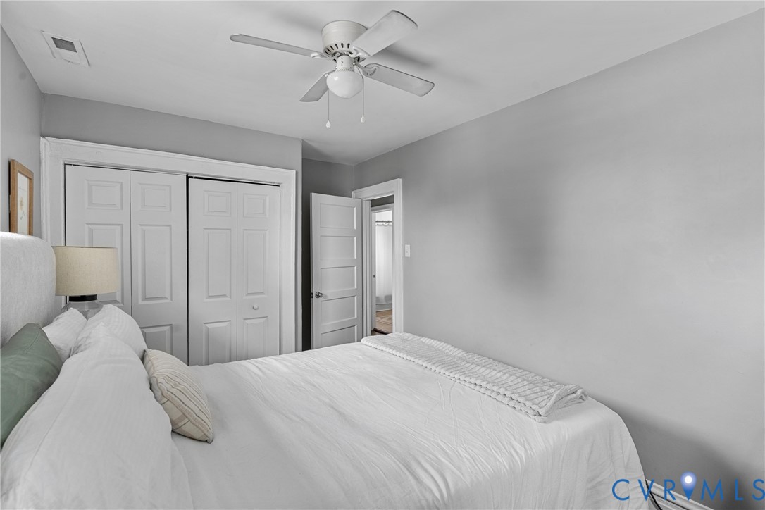 104 West Union Street Sandston, VA 23150 - Photo 21 of 33 a bedroom with a large bed and a chandelier