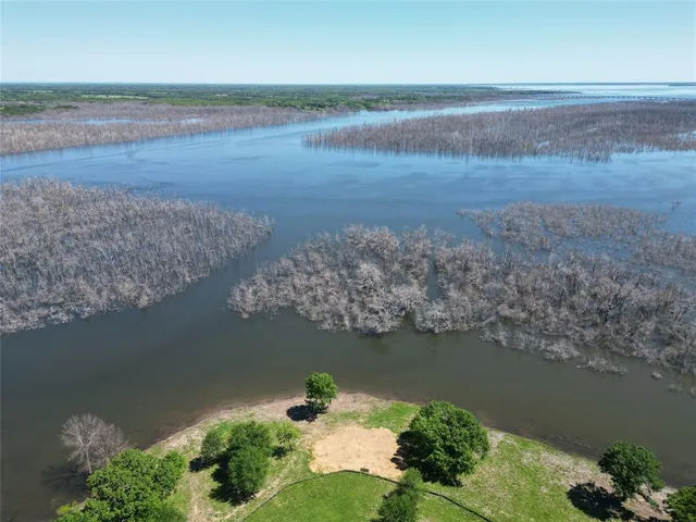 an aerial view of ocean with residential house and outdoor space