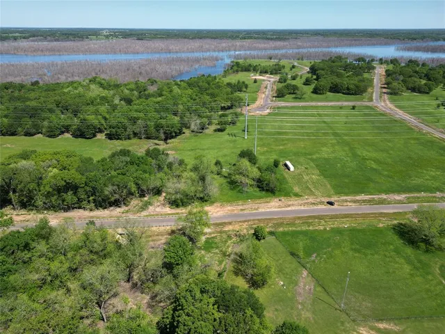 a view of a water pond with green field