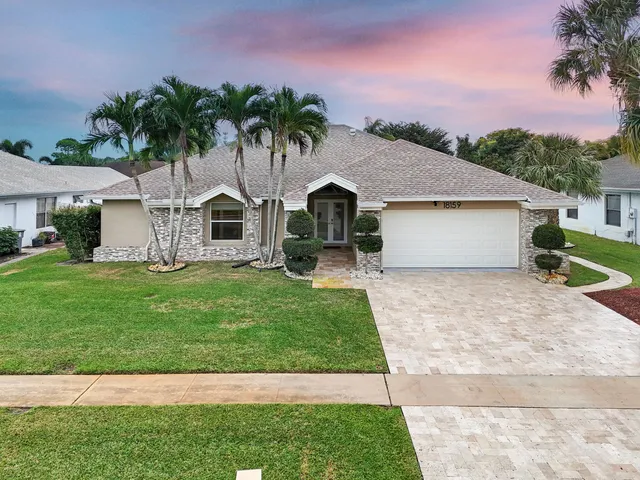 a front view of house with yard and green space