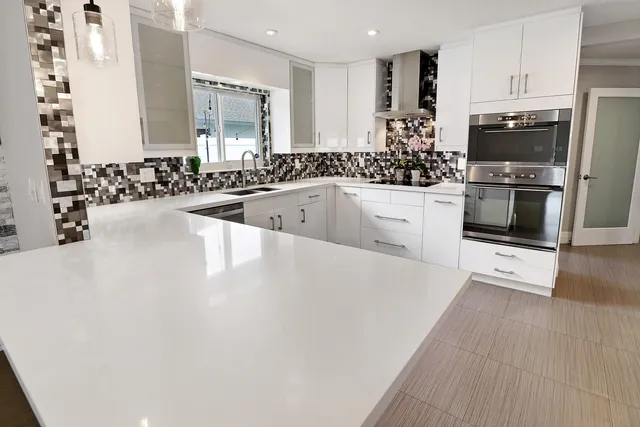a large bathroom with a granite countertop sink a large mirror and a shower