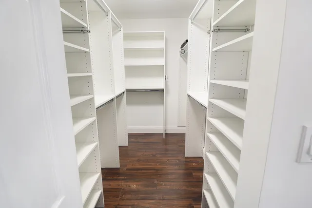 a view of a room with wooden floor and a bathroom