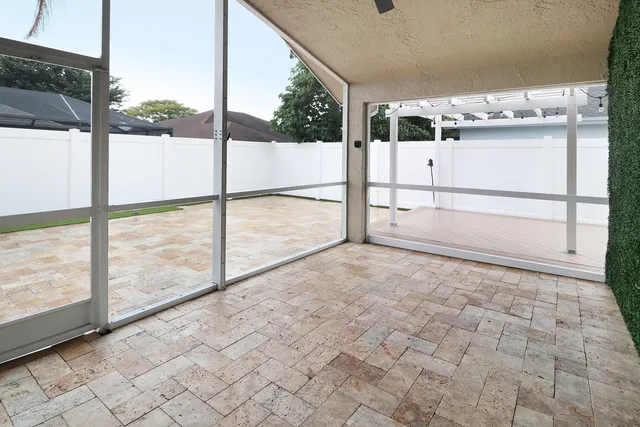 a view of house with swimming pool and porch