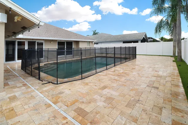a view of a house with a backyard