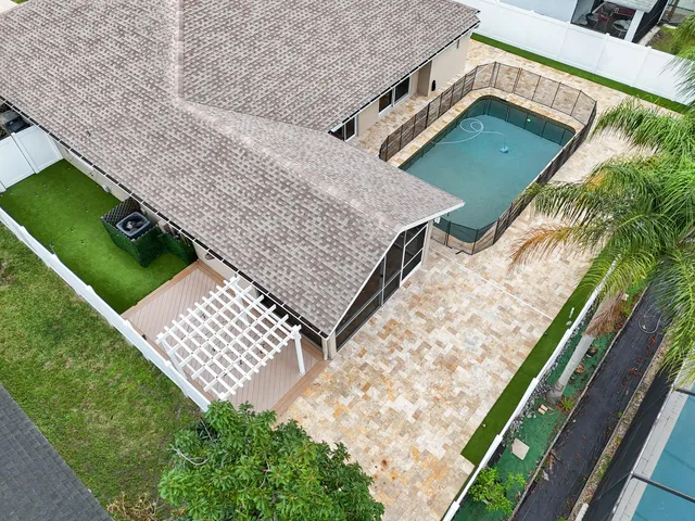 an aerial view of a house with a yard and potted plants