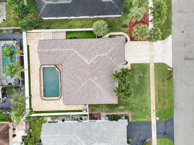 aerial view of a house with a yard and potted plants