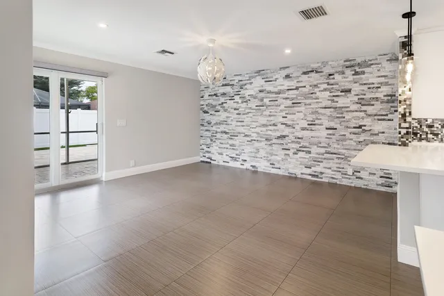 a view of a big room with chandelier and windows