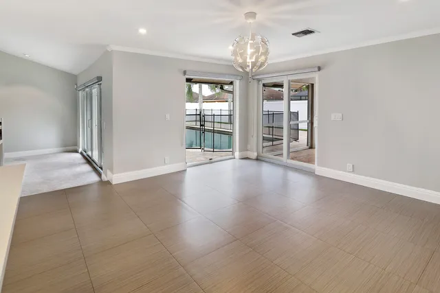 a kitchen with stainless steel appliances kitchen island granite countertop a refrigerator and a sink