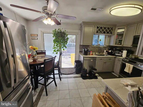 a kitchen with a table and chairs
