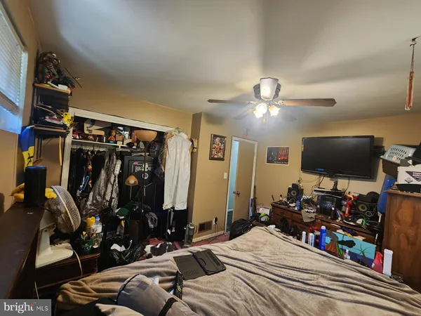 a bedroom with furniture and a flat screen tv