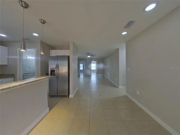 a view of a kitchen with a sink and a refrigerator