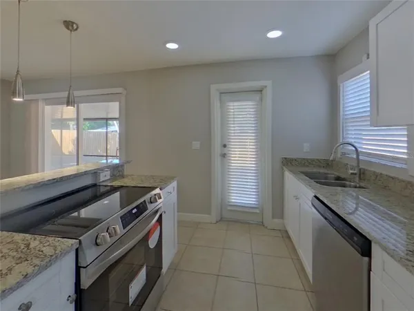 a kitchen that has a sink and a stove