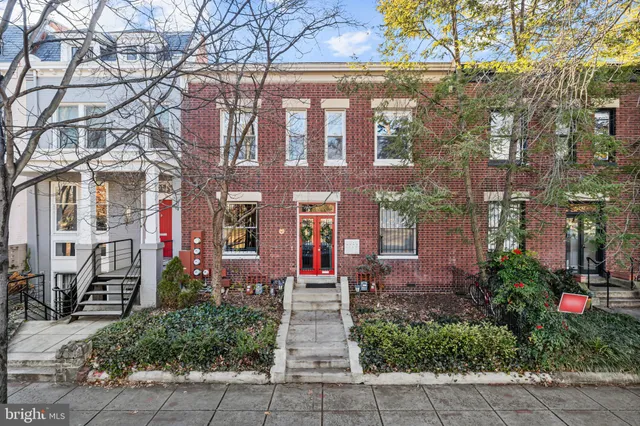 a front view of a multi story building with yard