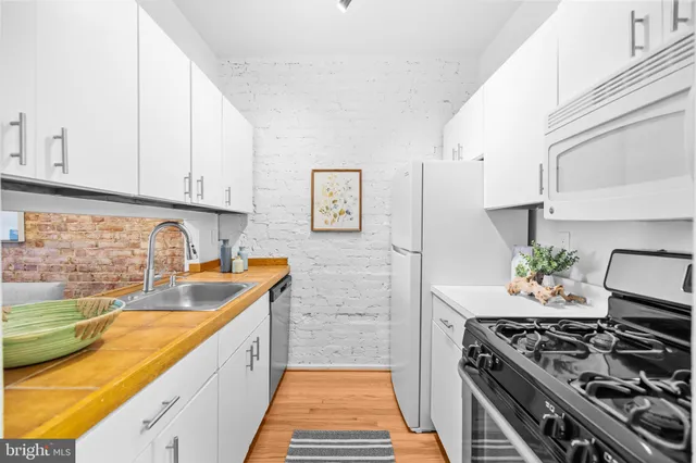 a kitchen with stainless steel appliances a stove a sink and a stove