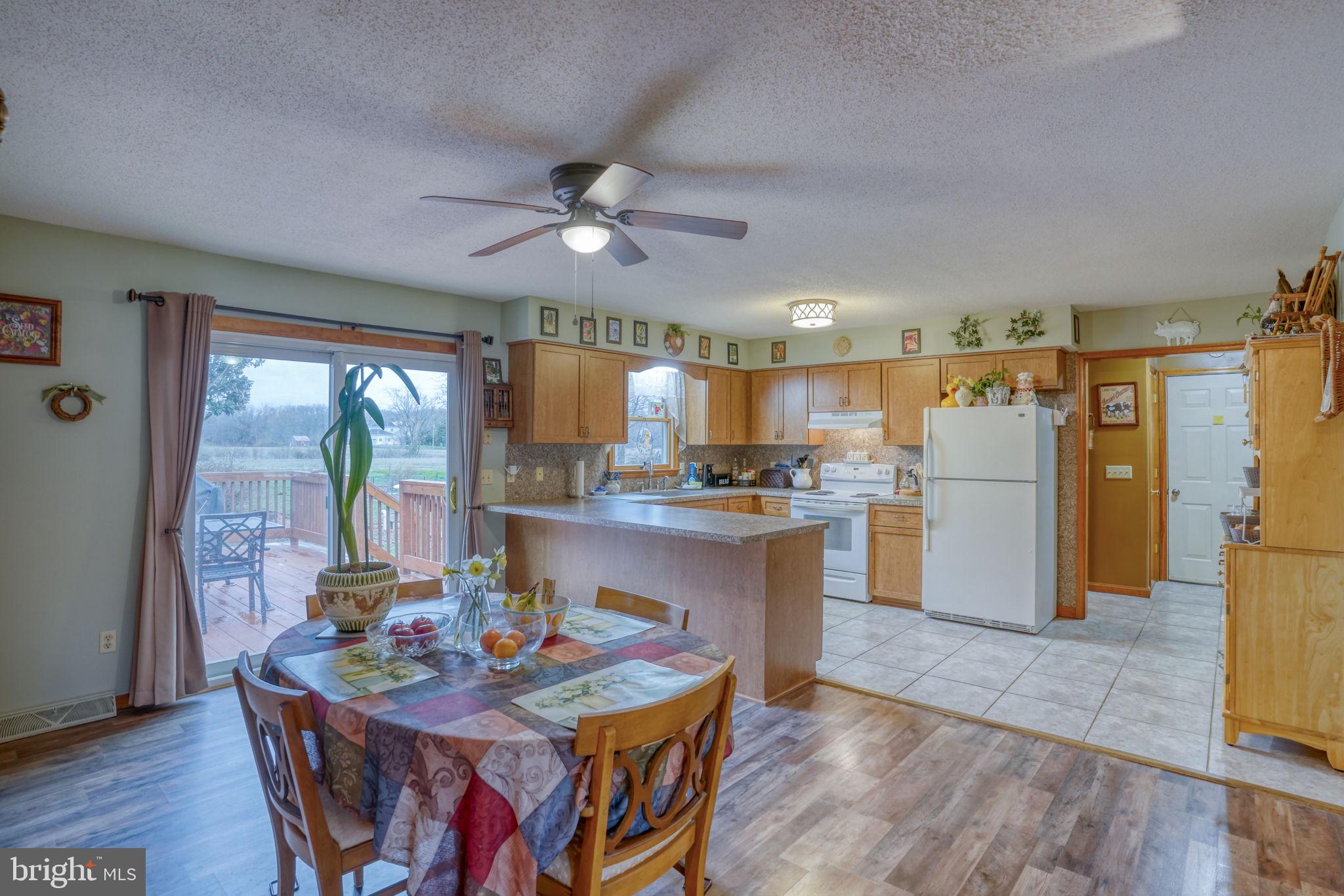 1916 Hartly Road Hartly, DE 19953 - Photo 13 of 44 a kitchen with stainless steel appliances granite countertop a refrigerator a sink a stove and island with wooden floor