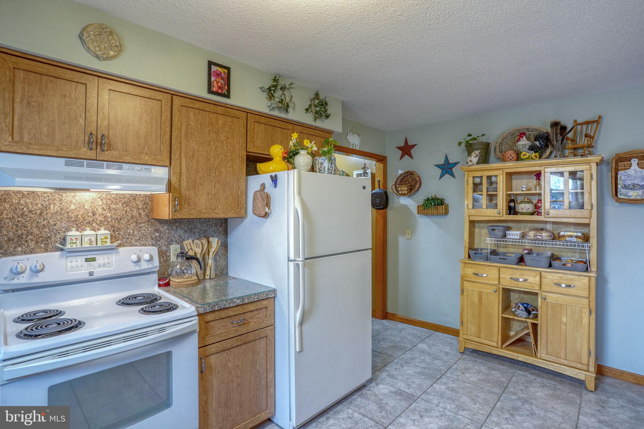 1916 Hartly Road Hartly, DE 19953 - Photo 19 of 44 a kitchen with a refrigerator a stove a washer and dryer