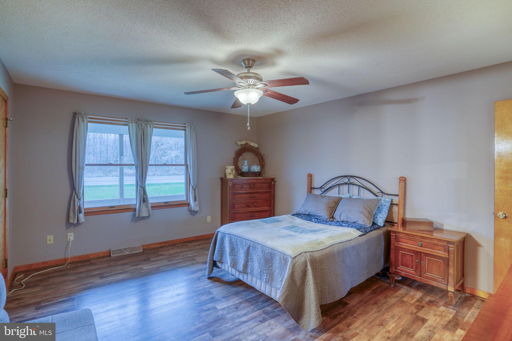 1916 Hartly Road Hartly, DE 19953 - Photo 24 of 44 a bedroom with a bed and a chandelier