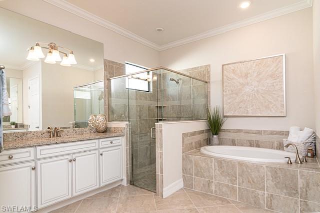2134 Antigua Lane Naples, FL 34120 - Photo 11 of 26 a spacious bathroom with a double vanity sink large mirror and a bathtub