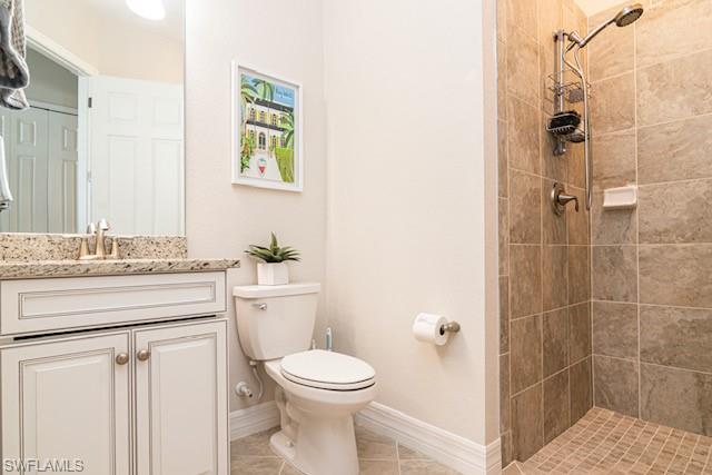 2134 Antigua Lane Naples, FL 34120 - Photo 13 of 26 a bathroom with a granite countertop sink toilet and shower