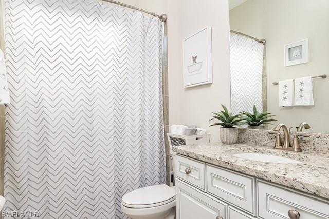 2134 Antigua Lane Naples, FL 34120 - Photo 15 of 26 a bathroom with a granite countertop sink and a mirror