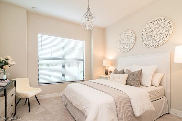 2134 Antigua Lane Naples, FL 34120 - Photo 16 of 26 a bedroom with a bed and a chair with the potted plants