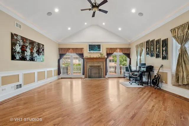 a living room with fireplace furniture and a wooden floor